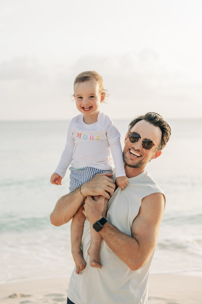 Parents and toddler having fun in the water during their Cayman family photos