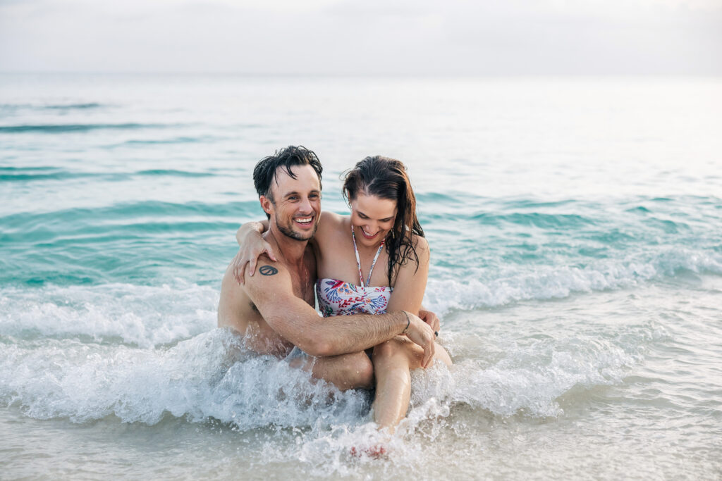 Parents and toddler having fun in the water during their Cayman family photos