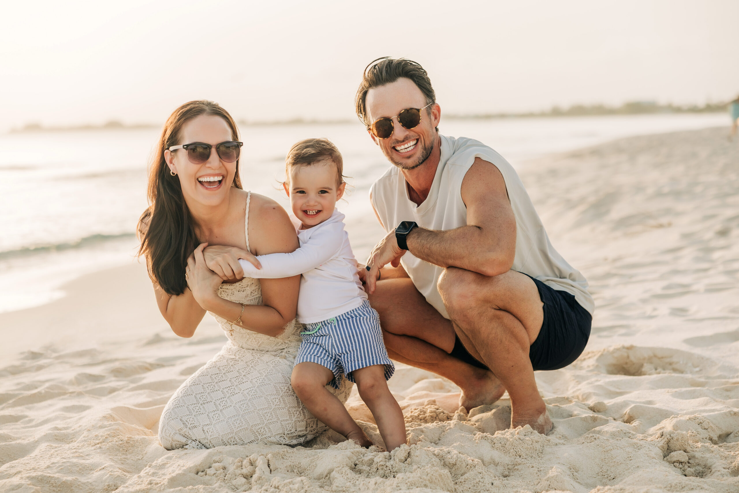 Family of three during a sunset beach session in Grand Cayman